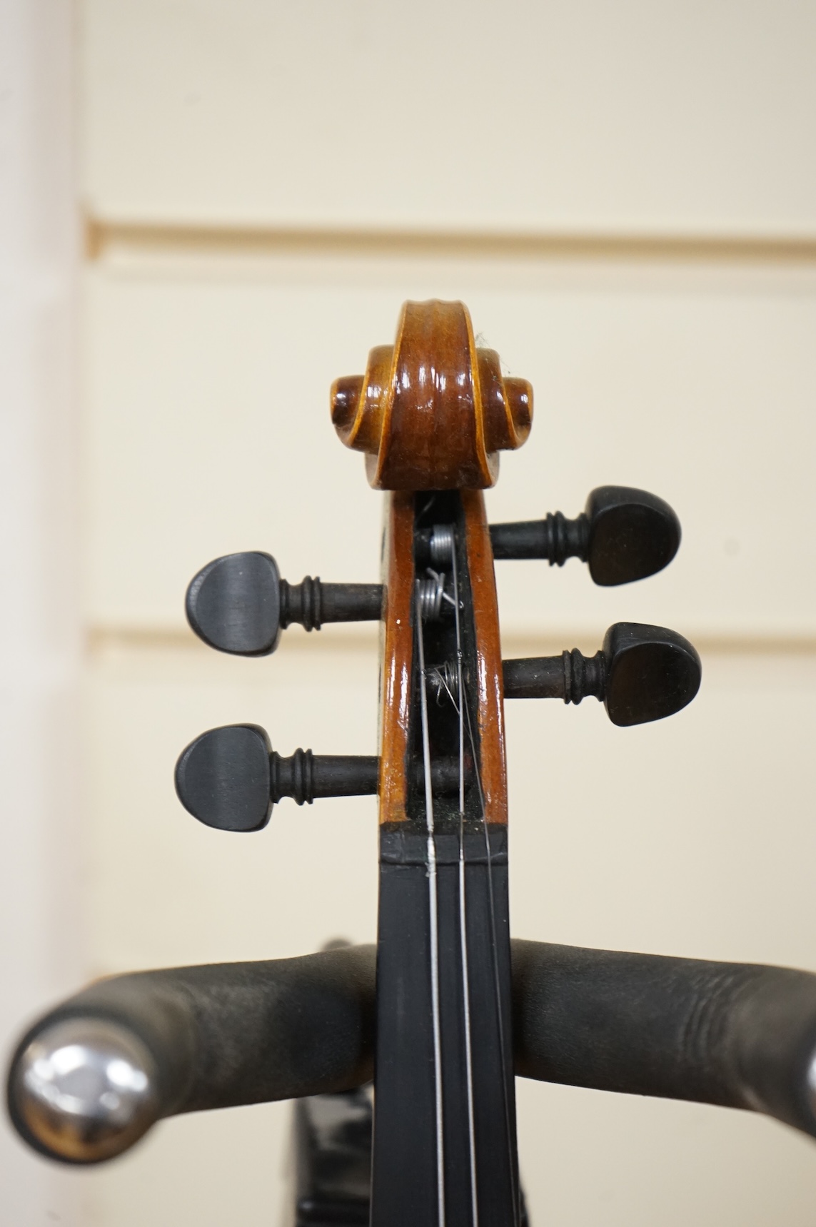 Five cased 20th century violins, including; a German violin, two Czech violins, a three-quarter size violin with a label for Bienfait, and a Romanian quarter size violin, all in cases or the remains of cases.